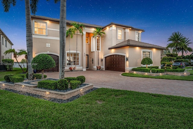 view of front of house featuring a yard and a garage