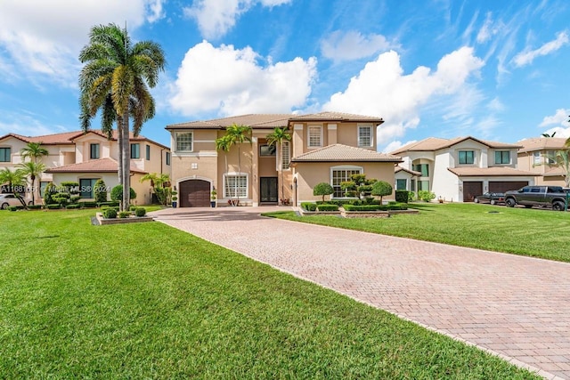 mediterranean / spanish-style house with a front yard and a garage