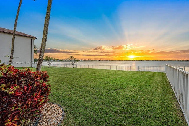 yard at dusk with a water view