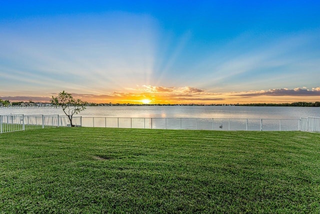 yard at dusk with a water view