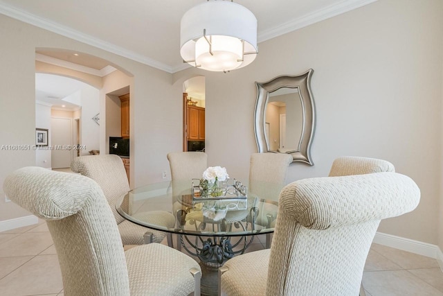 tiled dining area featuring ornamental molding