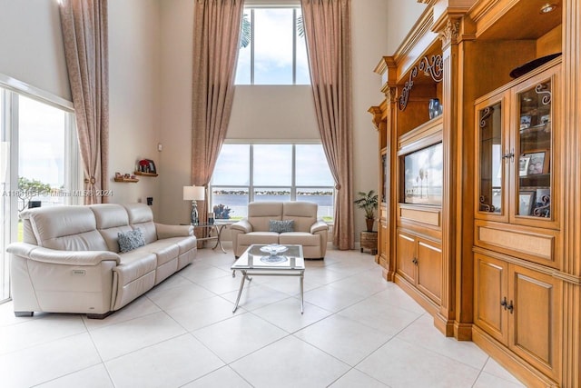 tiled living room featuring a towering ceiling