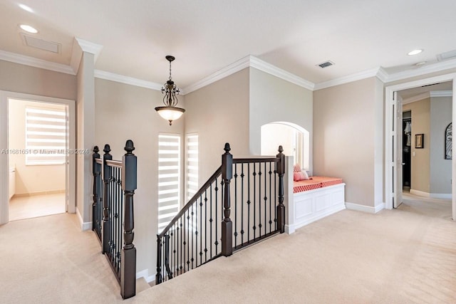 corridor with light carpet, ornamental molding, and a healthy amount of sunlight