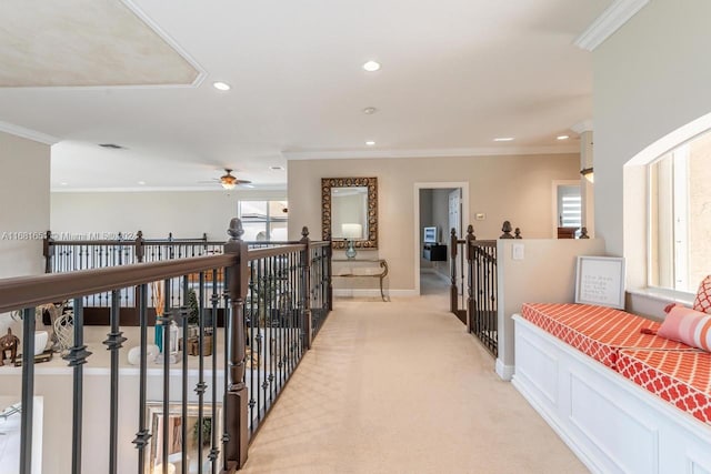 hallway with light carpet and crown molding