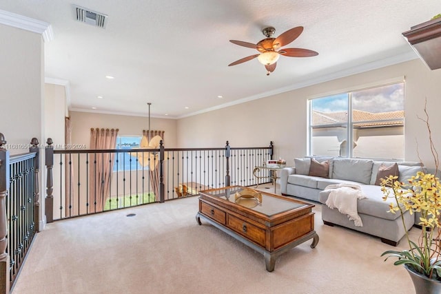 carpeted living room with crown molding, a textured ceiling, and ceiling fan