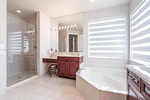 bathroom with a wealth of natural light, vanity, shower with separate bathtub, and tile patterned flooring