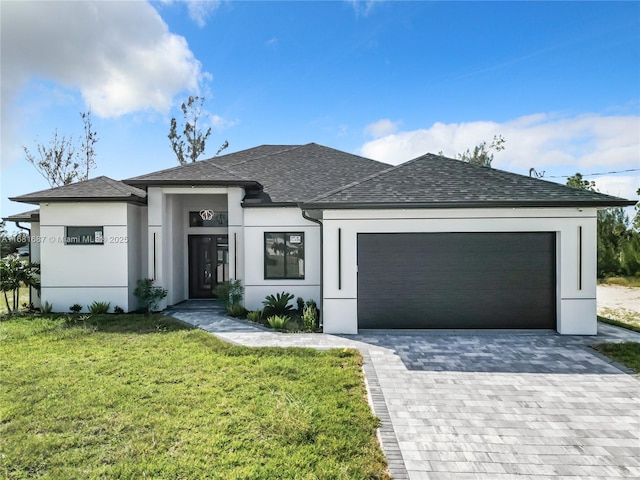 view of front facade featuring a garage and a front lawn