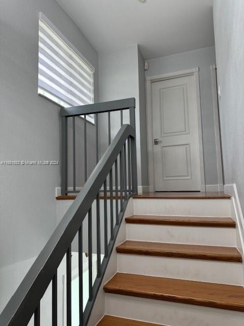 staircase featuring plenty of natural light