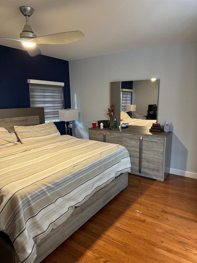 bedroom featuring wood-type flooring and ceiling fan