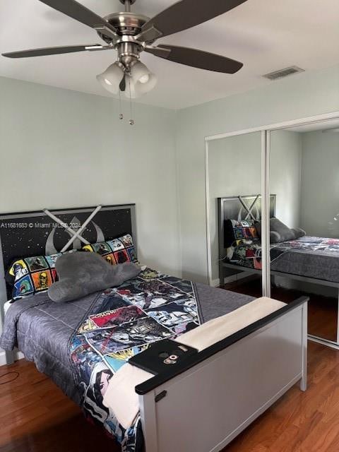 bedroom with a closet, ceiling fan, and hardwood / wood-style flooring