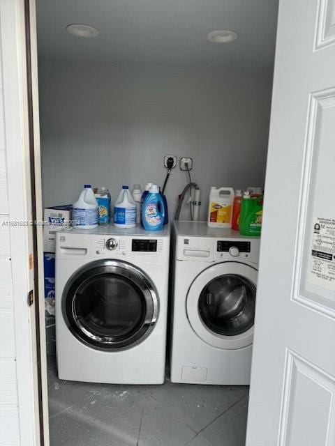 laundry area featuring washing machine and dryer and tile patterned flooring