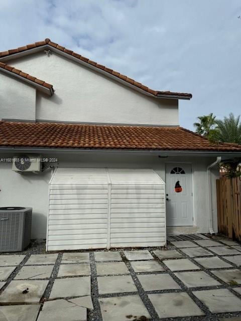 view of side of property with central air condition unit and a patio area