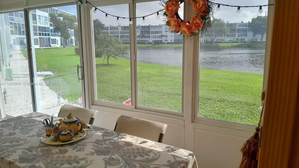 unfurnished sunroom with a water view and plenty of natural light