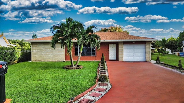 ranch-style house featuring a front yard and a garage