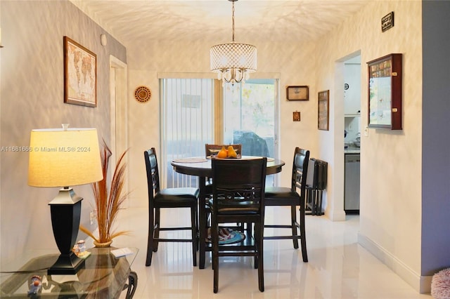 tiled dining area featuring a notable chandelier