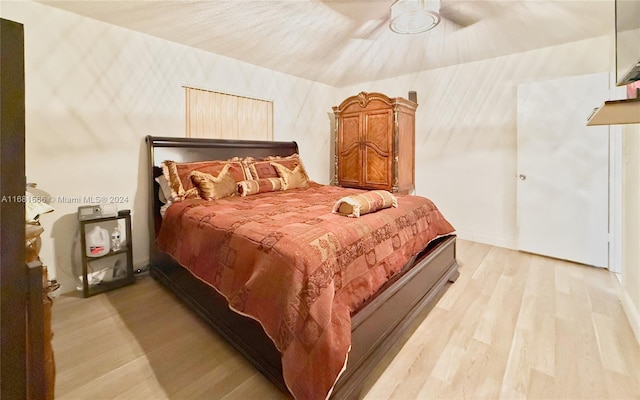 bedroom with ceiling fan and light hardwood / wood-style floors