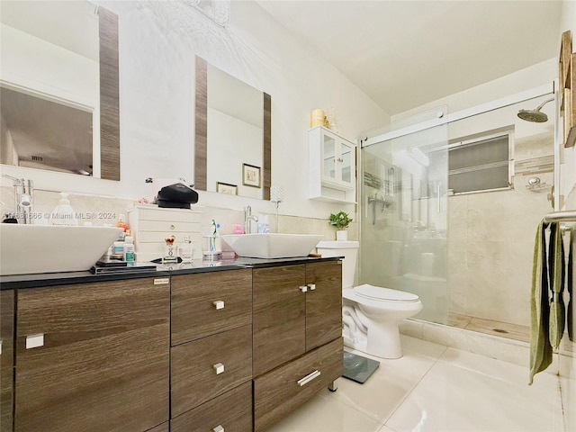 bathroom featuring vanity, toilet, tile patterned floors, and walk in shower