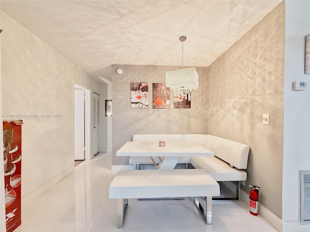 dining space with a textured ceiling and breakfast area