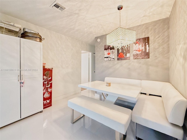 dining room featuring concrete flooring and a textured ceiling