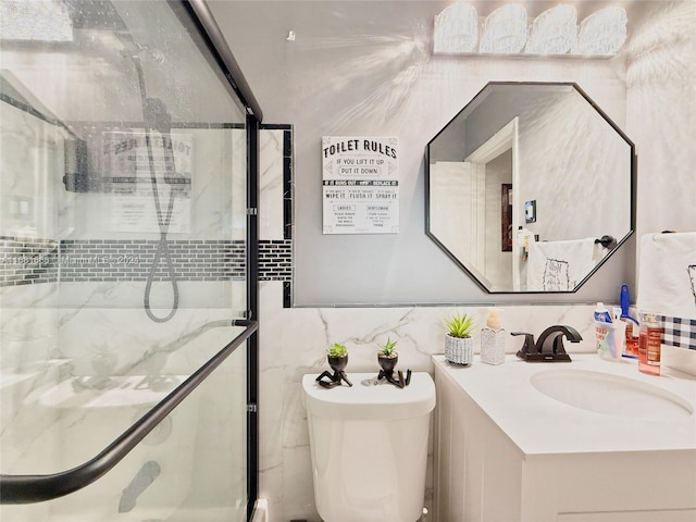 bathroom with toilet, an enclosed shower, vanity, and tile walls