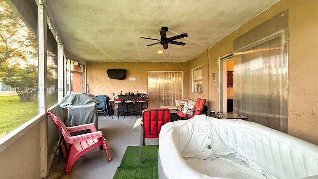 sunroom featuring plenty of natural light and ceiling fan