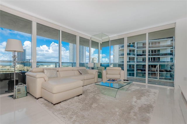 tiled living room featuring a wall of windows