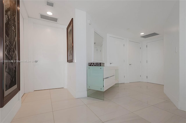 corridor featuring light tile patterned flooring