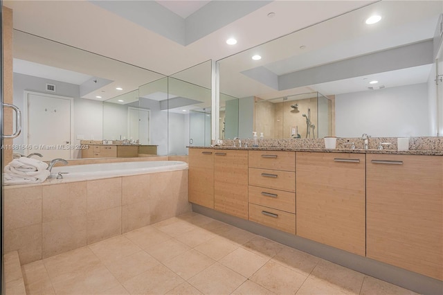 bathroom featuring tile patterned flooring, vanity, and shower with separate bathtub