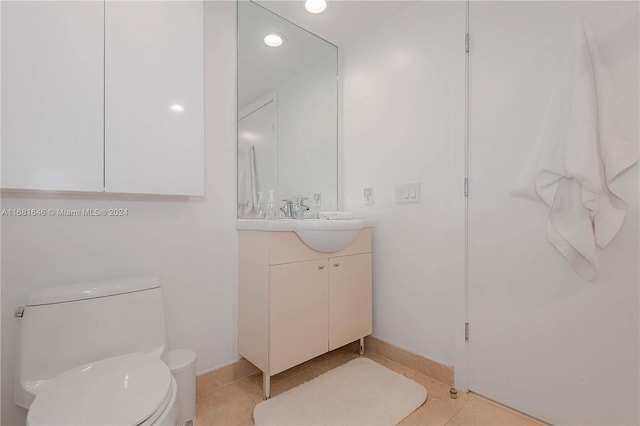 bathroom with tile patterned flooring, vanity, and toilet