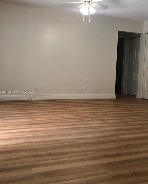 spare room with hardwood / wood-style flooring, ceiling fan, and a textured ceiling