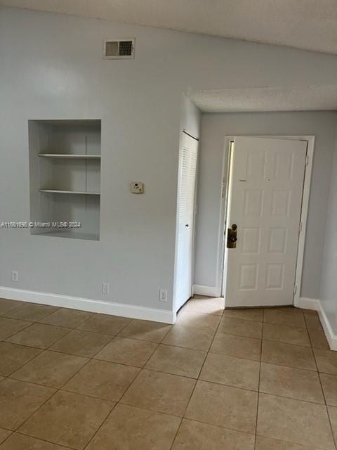 entryway with light tile patterned floors