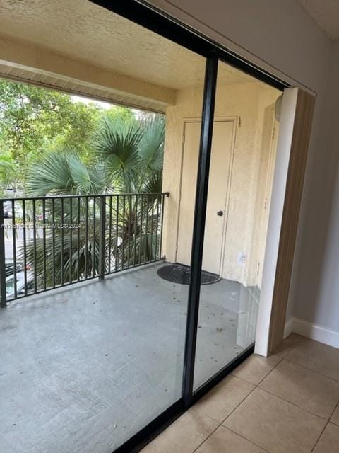 doorway to outside with light tile patterned floors and a wealth of natural light