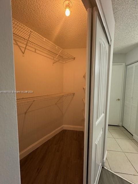 walk in closet with hardwood / wood-style floors