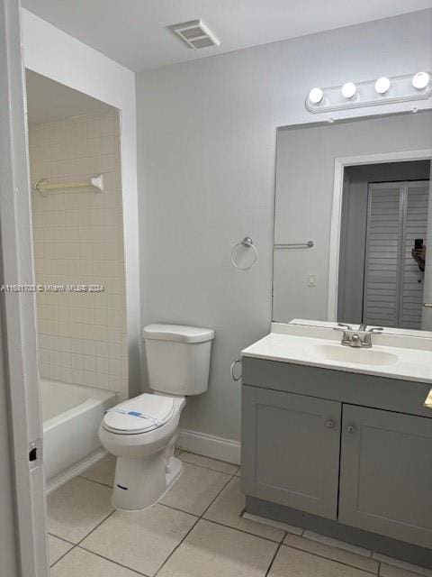 full bathroom featuring vanity, toilet, tile patterned flooring, and tiled shower / bath