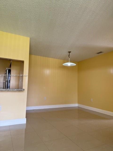 10018 NW 4th St Unit 203, Pembroke Pines, FL 33024 - unfurnished room with light tile patterned flooring and a textured ceiling