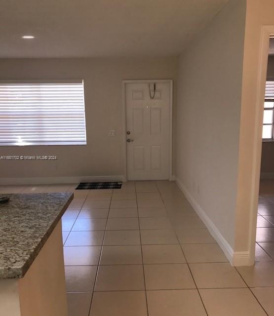 entryway featuring light tile patterned floors