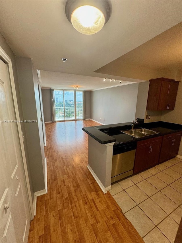 kitchen featuring floor to ceiling windows, dishwasher, light hardwood / wood-style floors, dark brown cabinetry, and sink