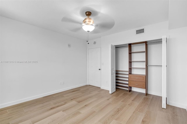 unfurnished bedroom with light wood finished floors, a closet, visible vents, a ceiling fan, and baseboards