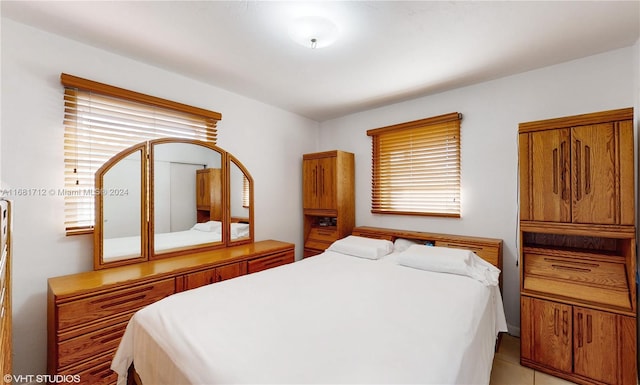 tiled bedroom with multiple windows