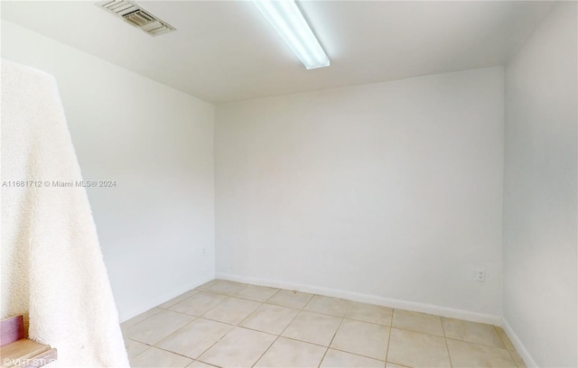 spare room with light tile patterned floors