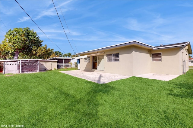 rear view of property with a patio area and a yard