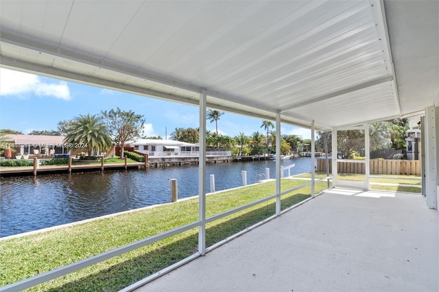 unfurnished sunroom featuring a water view