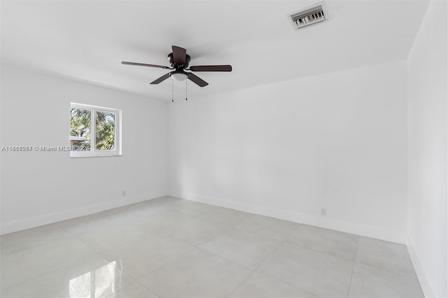 spare room featuring light tile patterned floors and ceiling fan