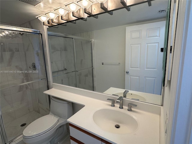 bathroom with vanity, toilet, and a shower with door