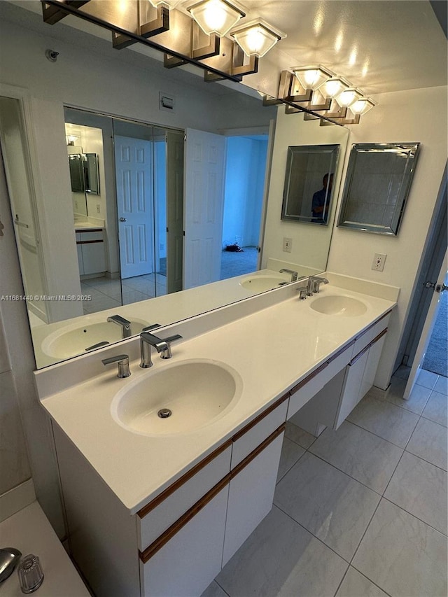 bathroom with tile patterned flooring and vanity