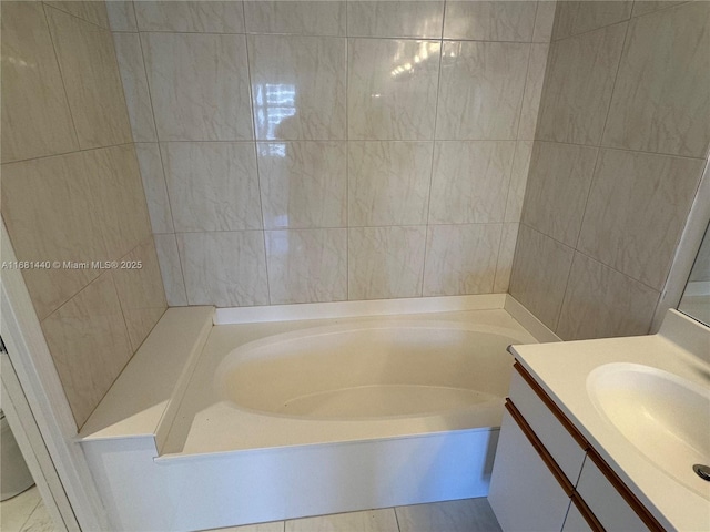 bathroom with a bathing tub and vanity