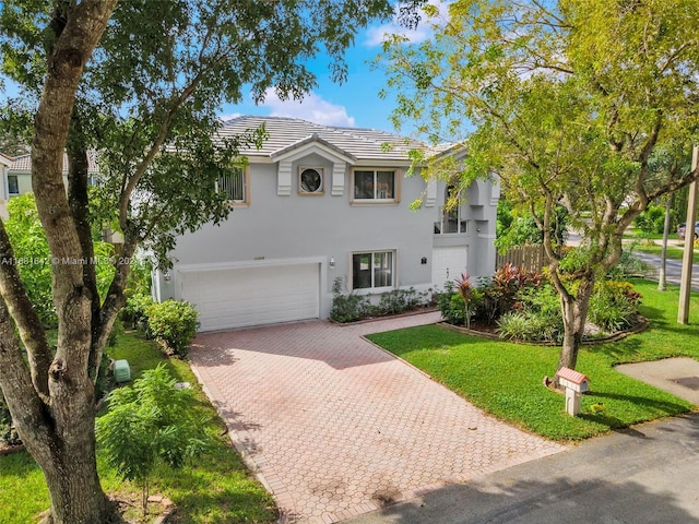 view of front of property with a garage and a front yard