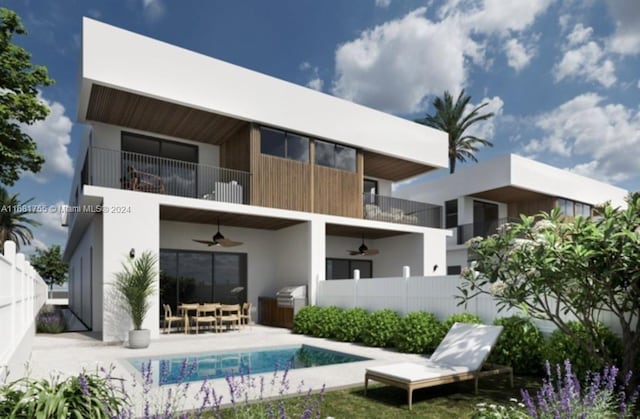 rear view of house with a balcony, a patio area, and ceiling fan