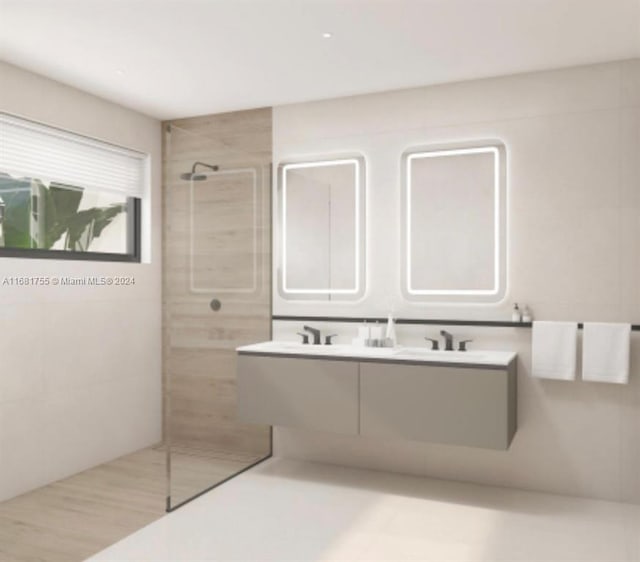 bathroom featuring vanity and tiled shower