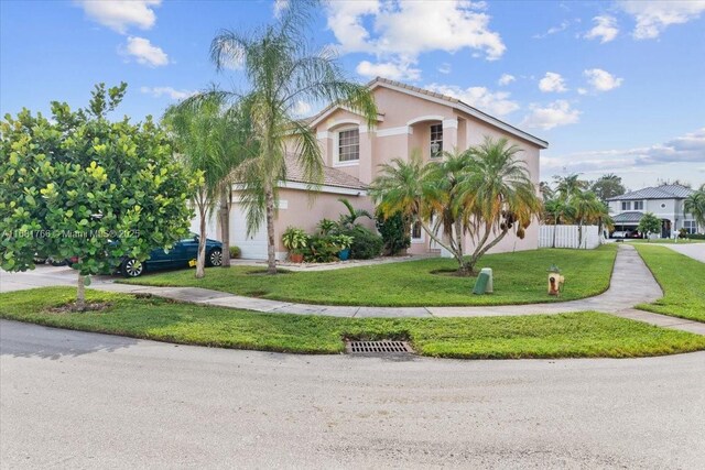 view of front facade featuring a front lawn and a garage